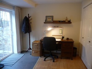Desk has office supplies and tourist brochures of the area.