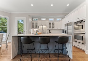 Fully stocked, remodeled kitchen with waterfall island.