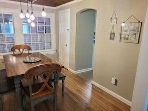 Dining room with windows looking into the laundry room.