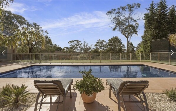 Solar-heated in-ground pool, fully tiled with large wide step in shallow end