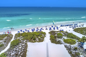Siesta Sands private beach on Siesta Key. Blue umbrellas for rent. It's here for you!