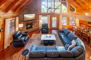 Stone fireplace, vaulted ceilings and relaxing views in Smoky Mountain Bless My Stars cabin.