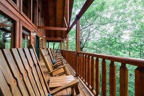 Double wrap around porch with rocking chairs in Smoky Mountain log cabin - Bless My Stars