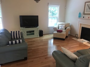 Living Room with TV, sound bar, and Roku.