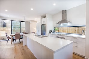A stylish, fully equipped kitchen with natural light and premium appliances for effortless cooking.
