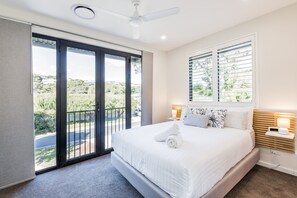 A private retreat featuring a queen bed, walk-in wardrobe, dedicated workspace, and ensuite.