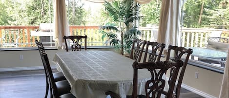 Dining area surrounded by large picture windows.  