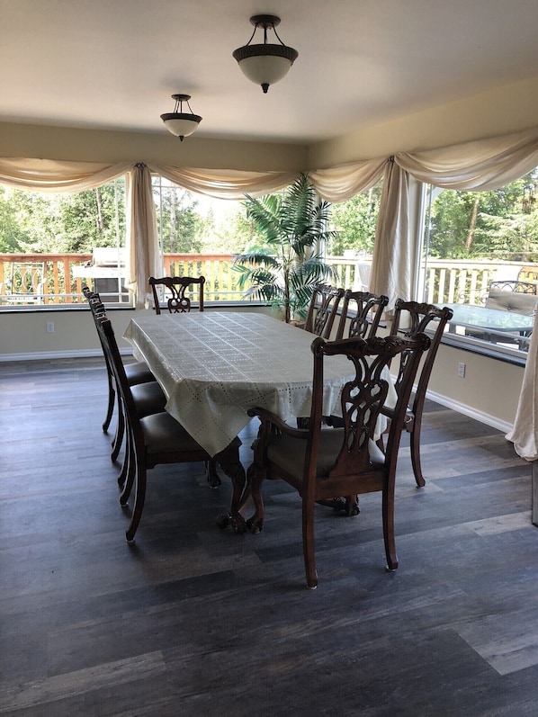 Dining area surrounded by large picture windows.