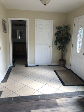 Entry way with half bath (opened door).