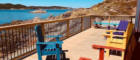 Sit on this ocean-front deck and observe the locals coming and going in the harbour, while gazing out to sea where you might just spot a breaching humpback or a passing iceberg.