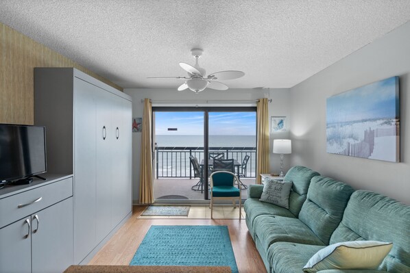 Relax in the comfort of a large well-appointed living room with an ocean view.