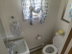 1/2 bathroom (toilet and sink) near washer and dryer