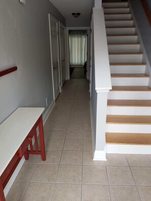 Entry way first floor. Hallway leads to one of two master bedrooms.