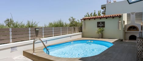 Swimming pool with sunbeds and traditional oven