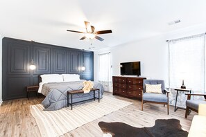 Master bedroom upstairs with seating area and en suite bathroom featuring double vanities, a soaker tub plus a shower.