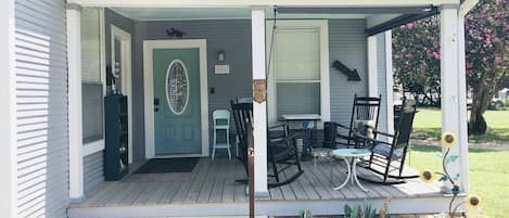 Large front porch is perfect for relaxing with book or cup of coffee