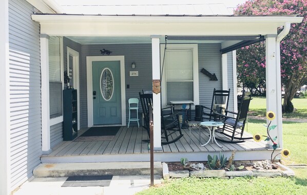 Large front porch is perfect for relaxing with book or cup of coffee