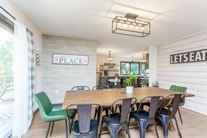 Gather and dine in style in this spacious dining area, featuring seating for eight. Perfectly positioned in an open-concept layout, the dining area flows seamlessly into both the kitchen and living room, making it an ideal space for entertaining or family meals. Natural light fills the room, enhancing its welcoming ambiance and making every gathering feel special.