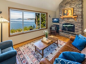 Relax in the family living room and enjoy the view of Spieden Island. 
Smart TV shown.  
(Fireplace not for guest use)