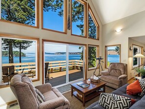 Living room with two captains chairs and a couch.