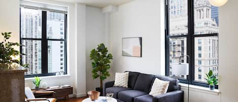 Spacious living room and kitchen filled with light throughout the day