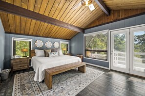 Upstairs king bedroom has a picture window and a balcony with mountain view
