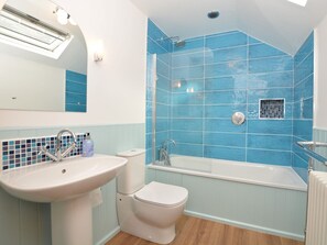 Bright airy bathroom with full sized bath for and shower, heated towel rail