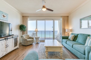 Living Room | Breathe Easy Rentals - Beautiful view of the ocean waters with access to your private balcony. Flat screen tv with cable and wifi.