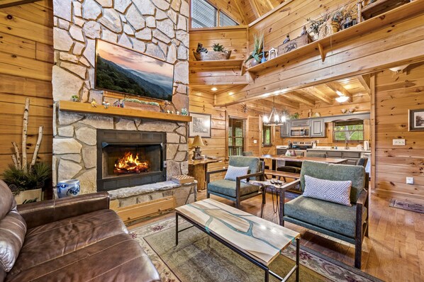 Walk into an updated living room with stone gas fireplace and cable TV. 