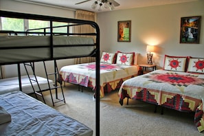 1st bedroom on main floor with 2 queen beds and 2 twin bunkbeds