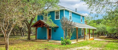 This beautiful sky-blue guest home sits so peacefully in the country, it's hard to believe it's just a few miles from Bandera!