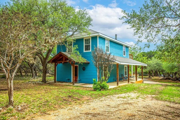 This beautiful sky-blue guest home sits so peacefully in the country, it's hard to believe it's just a few miles from Bandera!