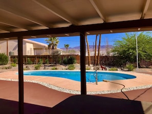 recently refinished pool, water, deck and landscaping