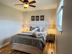 Queen bedroom on main floor with ceiling fan