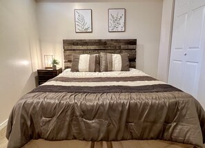 Basement queen bed with plenty of closet space