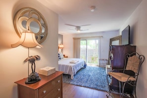 The large bedroom suite features a king bed and access to a private outdoor courtyard.