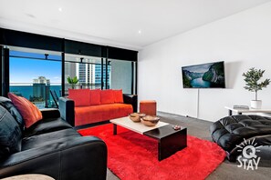 Living room overlooking the ocean and the city