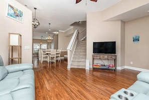 Living Room Area with TV and Stair to Upstairs