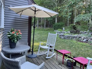 Outside private deck overlooks perennial garden and woods.