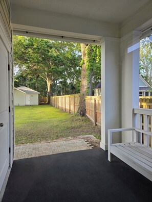 Spacious backyard & comfy porch seating awaits. 