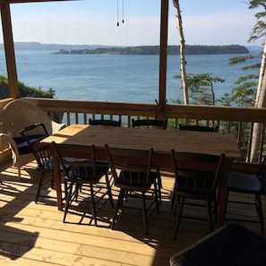 One of the two screened in porches with dining table.