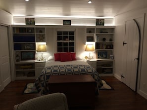 MATER BEDROOM WITH BUILT IN BOOKCASES AND FIREPLACE.