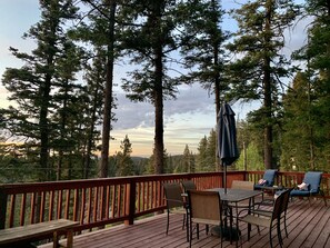 Large back deck with picnic table and lounge chairs