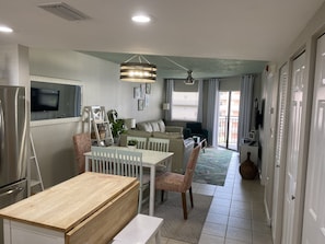 View of the  table and living room. Seats 6 and two bar stools on the island