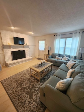 Adjacent to the Living Area, Cozy Fireplace and Lounge Space Perfect for Family Gatherings.