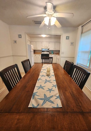 Elegant Dining Space with Seating for Six, Seamlessly Connected to a Fully Equipped Kitchen.