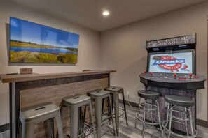 Game room with classic arcade and oak bar