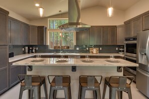 Kitchen area with stainless-steel appliances and large island