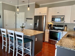 Updated kitchen with island seating. Fully stocked for all your cooking needs.