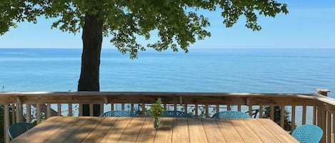 Large lakeside deck ready for outdoor meals.